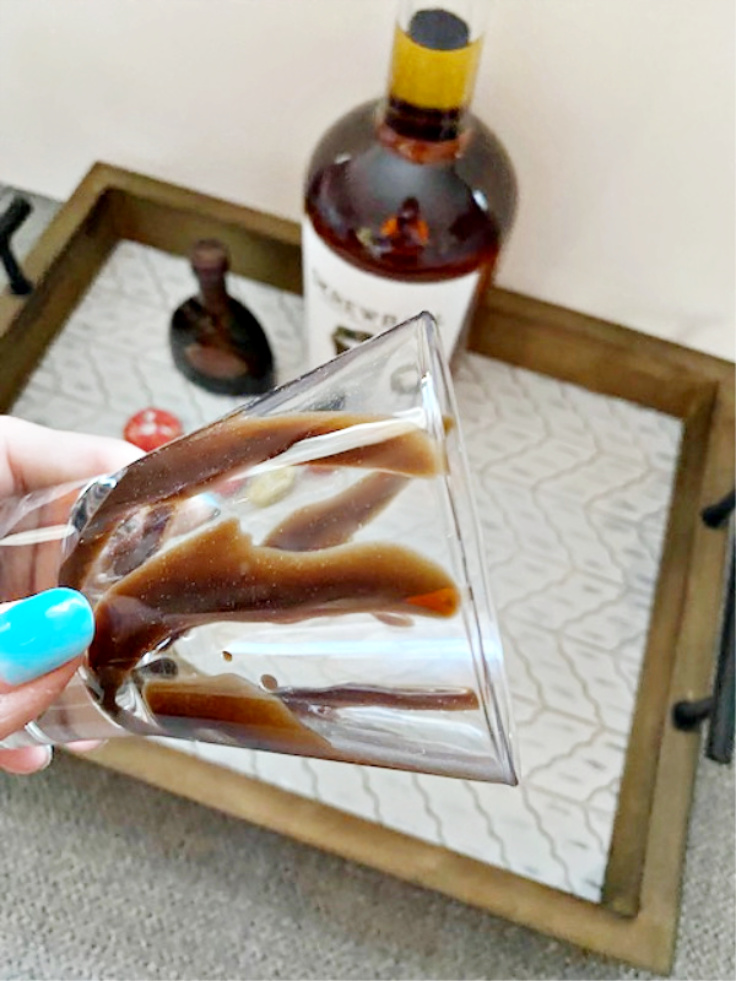 chocolate syrup added to whiskey glass