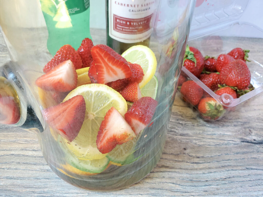 strawberries in pitcher for red wine sangria